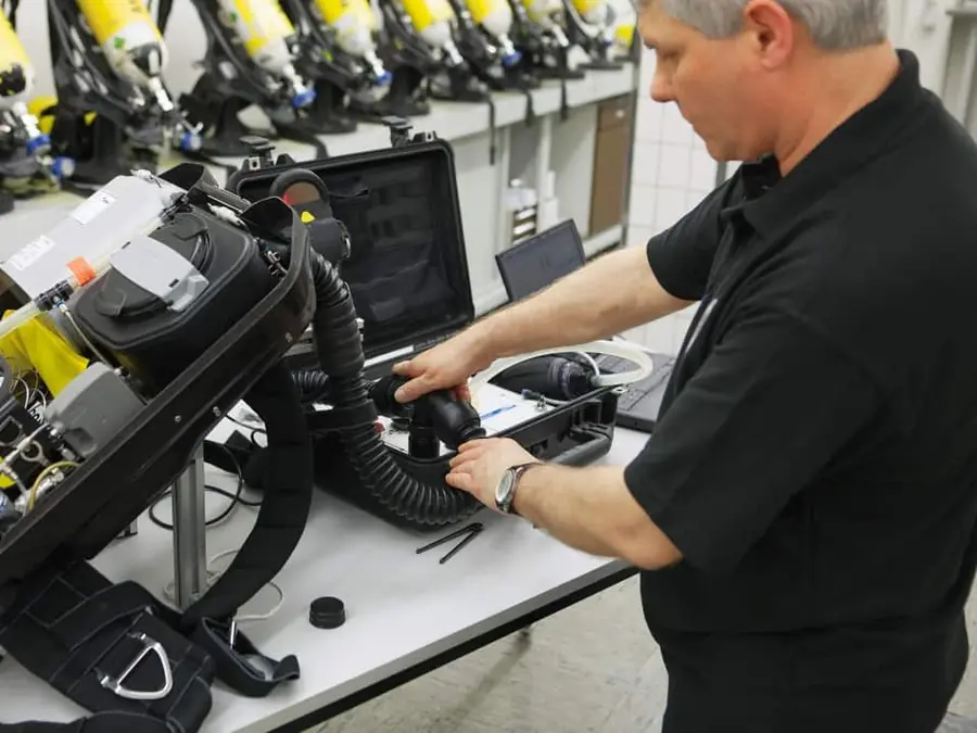 Technician servicing breathing equipment